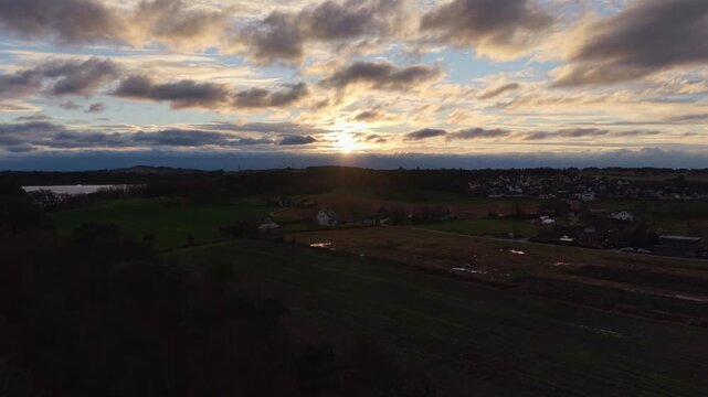 A drone aerial focused on a blue sky partially covered by soft, scattered clouds. The view emphasizes the atmosphere rather than the ground, showcasing gentle cloud formations, subtle light variations