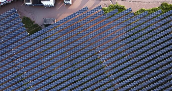 Aerial shot of solar panel farm installed on mudflat coastal area for renewable energy generation.