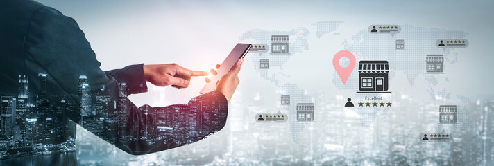 A businessman interacts with a smartphone displaying location services over a digital map,...