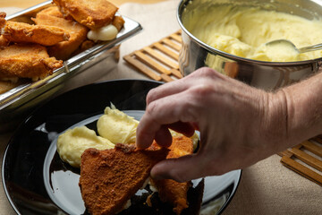Cheese in breadcrumbs with smashed potato
