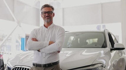 Confident smiling happy adult man customer male buyer client wears white shirt chooses auto wants to buy new automobile in car showroom vehicle salon dealership store motor show indoor. Sales concept