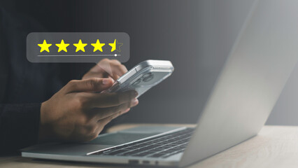 Customer giving online review on mobile phone, rating service with 4.5 stars. Concept of feedback, satisfaction, survey, user experience, and business quality.