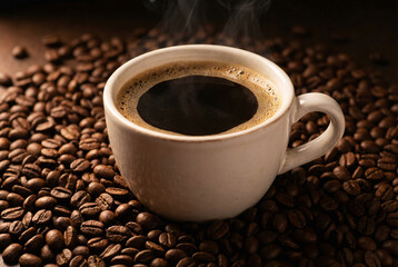 Fototapeta premium Steaming black coffee in white cup on roasted beans, hot espresso breakfast drink, cafe, caffeine and energy concept.