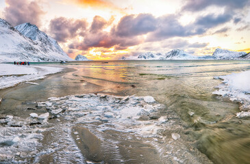 Stunning winter scenery with Haukland beach during sunset and snowy  mountain peaks near Leknes.