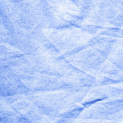 Light blue crumpled paper texture background, wrinkled fabric surface, pastel abstract grunge, soft textile pattern for design, print, web, presentation, banner.