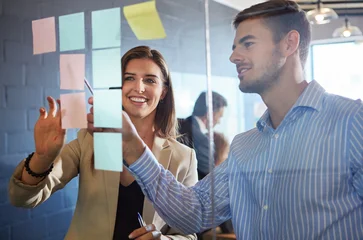 Fototapeten Pony Planning, sticky notes or people in meeting with glass wall, feedback or idea for company proposal. Happy, team or marketing director in office with board, collaboration or brainstorming for campaign  © peopleimages.com