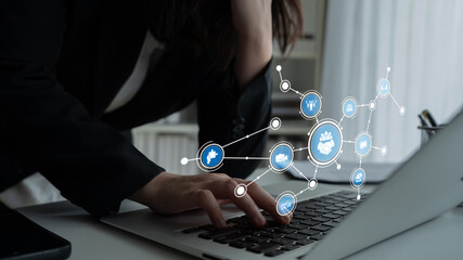 A businessperson interacts with a laptop in a modern office, surrounded by digital icons representing connectivity and data analysis, showcasing innovation and productivity. Tessel