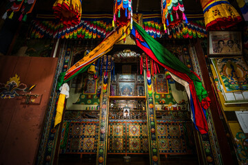 Ha, Bhutan - 26 September 2025: View of the vibrant altar adorned with intricate carvings and colorful fabrics, creating a mesmerizing cultural gateway.