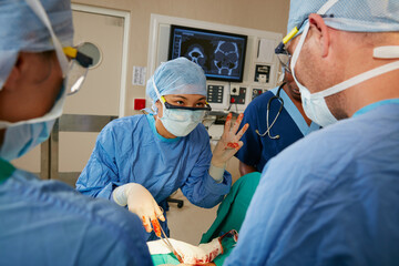 Hand gesture, healthcare or surgery and doctor with team in hospital together for procedure on...