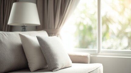 Fototapeta premium A soft white cushion resting against a neutral background, creating a calm and minimal setting that highlights comfort, cozy living, simple home decor and a clean modern interior atmosphere