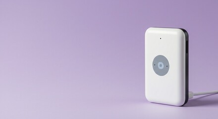 Portable device with a sleek design and a minimalist aesthetic, sitting on a light purple backdrop.