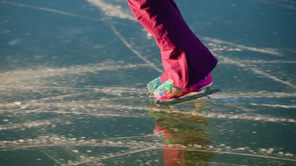 A skillful figure skater gracefully glides across a shimmering ice surface, showcasing vibrant, colorful skates that leave delicate trails as sunlight reflects off the frozen pond, evoking a sense of