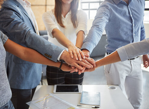 Business, people and meeting with handstack in office for good news, real estate success and celebration. Staff, huddle and team achievement for property deal, realtor motivation and auction victory