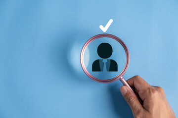 Magnifying Glass Over Iconic Figure Silhouette, Symbolizing Search, Analysis, or Assessment in Professional Context