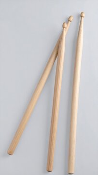 Three drum sticks on light background