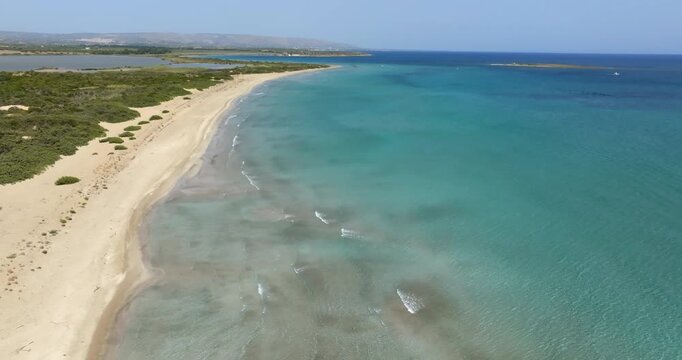 Aerial view of San Lorenzo beach in the Province of Syracuse, Sicily, Italy. The sandy beach overlooks a crystal-clear sea. It is located near the Vendicari Nature Reserve.