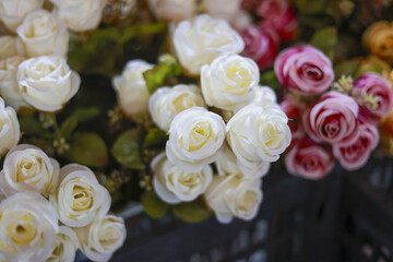 Romantic and delicate close up of an artificial rose flower bouquet. white and pink blooms make beautiful decoration for wedding or event, with soft background