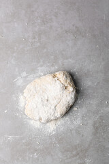 Overhead view of scallion pancake dough being mixed on a grey countertop, top view of cong you bing dough being mixed, process of making scallion pancakes