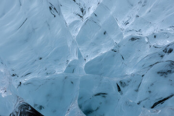 Crystalline Ice Cave: A mesmerizing display of intricate textures and ethereal blue hues unfolds within a captivating ice cave, showcasing nature's artistry.