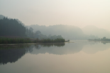 Misty Morning Lake Reflection in Wofo Town Anyue Sichuan China