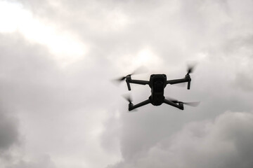  September 10, 2022, Carpathian Mountains, Ukraine. quadrocopter Mavic flies against a gray cloudy sky. Blur and selective focus.