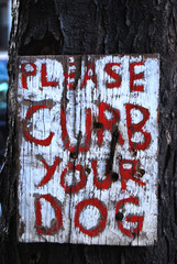 A view of Please curb your dog sign 