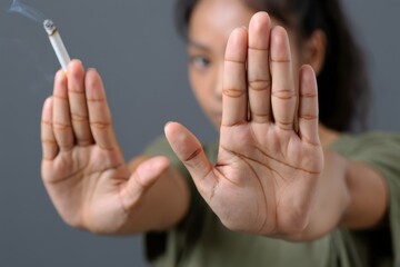 Woman Holding Up Hands to Reject Cigarette - Stop Smoking Campaign