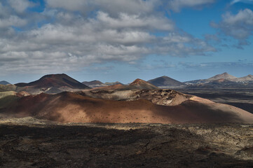 Dramatic volcanic landscape and red earth of Timanfaya National Park, an otherworldly scenic tourist attraction, Lanzarote, Spain