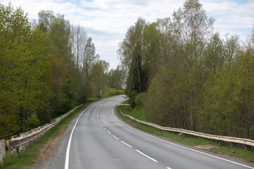 Silent Spring Highway Surrounded By Latvian Green Forests