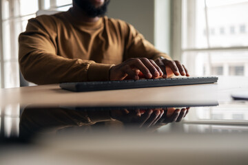 Close-Up of Professional Typing at Desk in Modern Office Setting
