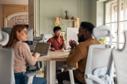 Collaborative Team Meeting in a Vibrant Modern Office Setting - Powered by Adobe