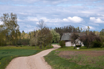Winding Gravel Road Leading to Latvian Farmhouse