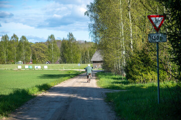 Senior Cyclist Riding Rural Latvian Road