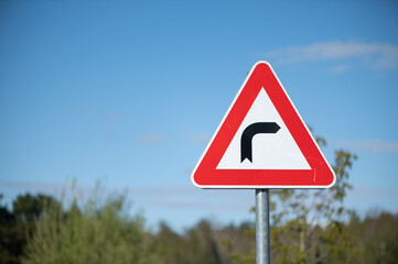 Bright Latvian countryside warning sign under clear blue sky