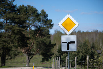 Close Latvian countryside priority and turn signs