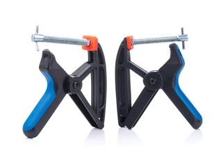 Two black plastic clamps with blue handles, isolated on white