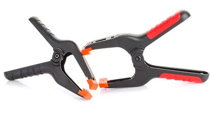 Two black plastic clamps with red accents, isolated on white