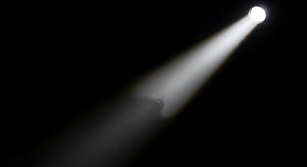 Focused Spotlight Beam Illuminating Darkness - A Single Source of Light.