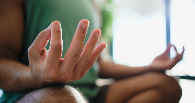 Fitness, hands and meditation with man in home studio for balance, inner peace or mindfulness. Exercise, mudra and yoga with person in apartment for holistic health, lotus pose or wellness routine