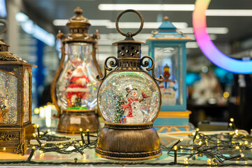 Festive snow globes and lanterns display with christmas lights