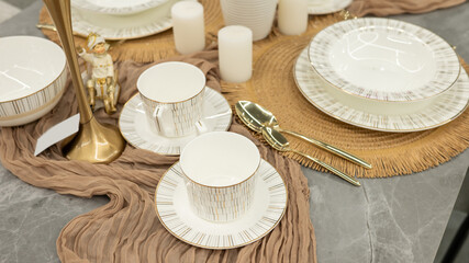 Elegant table setting with gold-rimmed china and decorative figurine