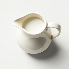 White ceramic pitcher filling with fresh milk
