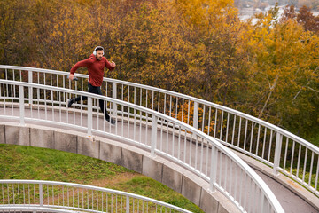 Man Jogging on Curved Pathway in Autumn Park Scenic View