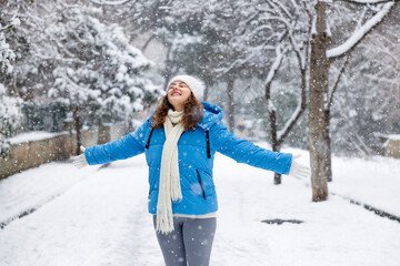 Young woman enjoying a snowy winter day
