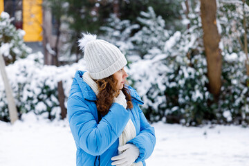 Young woman in warm clothes on a cold snowy day