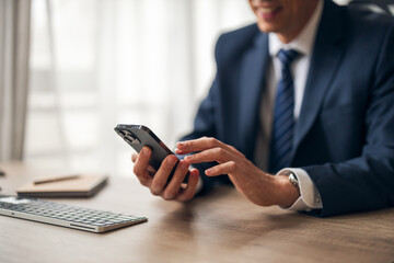 Business Professional Using Smartphone in Modern Office Setting