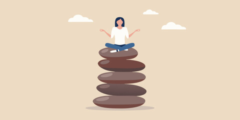 Woman meditating on a stack of balanced stones seeking inner peace