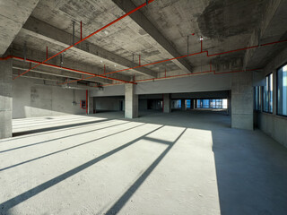 Fototapeta premium Exploring the Vast Potential of an Empty Industrial Space Bathed in Natural Light