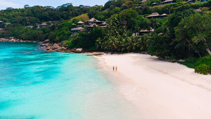 couple relax on beach resort in tropics. Luxury traveling together. Seychelles.