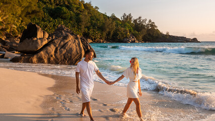 travel for newlyweds, couple holding hand, walking along beautiful white sand beach in summer on tropical beach